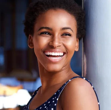 Smiling woman enjoying her dental care experience